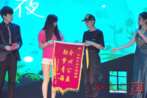 三、南京老民警为七校联盟成员颁发锦旗“全心公益 助梦青海”，鼓励同学们继续坚持公益事业。（王瑞雪 刘宏宇摄）